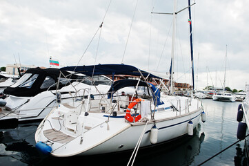  Marine parking of modern motor boats. Luxury yachts docked in sea port.
