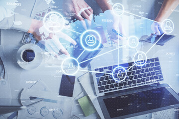 Double exposure of man and woman working together and social network theme hologram drawing. Computer background. connecting concept. Top View.