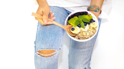 Top view of woman eating Healthy blueberry parfaits in bowl,Diet food concept