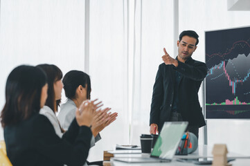 Businessman applauding congratulations with a smiling face during the workshop in the conference room. Brainstorming and teamwork concept.