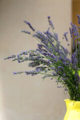 Yellow vase with fresh lavender flowers. Selective focus.