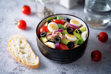 Canned Tuna red onion egg cucumber salad in a bowl