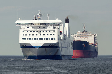 MARITIME TRANSPORT  - Passenger ferry and bulk carrier on waterway to the port 
