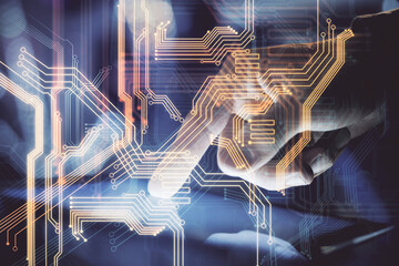 Double exposure of man's hands holding and using a digital device and tech theme hologram drawing. Technology concept.