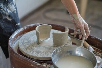 Female Potter creating a earthen jar on a Potter's wheel