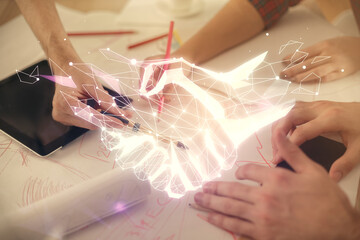 Double exposure of handshake hologram and man and woman working together holding and using a mobile device.