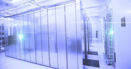 Computer servers in a server room with glowing lights