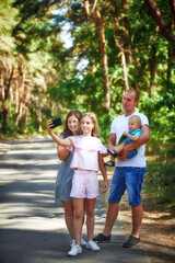 Photo of family taking selfie in the nature