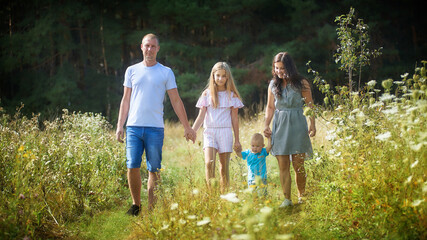 Fototapeta premium Outdoor portrait of family with two children