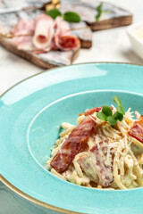 Homemade Carbonara pasta with bacon, parmesan cheese and cream sauce. Italian food concept. Food recipe background. Close up