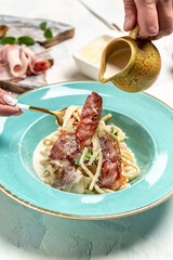 Pasta Carbonara. Spaghetti with bacon, parmesan cheese and cream sauce. Italian food concept. Food recipe background. Close up