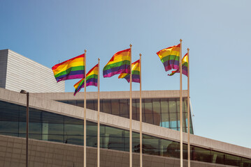 An Annual LGBT Pride Celebration in Oslo, Norway.  Rainbow flags by the side of Oslo Opera building. - obrazy, fototapety, plakaty