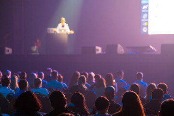 Unrecognizable people listening to speaker during business conference