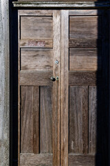 An old wooden door glows in the sun.