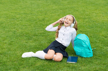 Lesson in music. Happy kid listen to music in headphones. Get singing lessons. School education