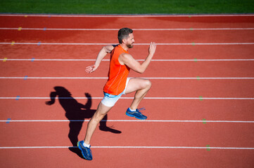 Fototapeta na wymiar challenge and competition. marathon speed. sprinter. energetic man on running track.