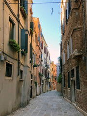 Fototapeta na wymiar venetian canal and old brick houses in Venice, Italy