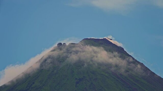 Arenal Volcano active andesitic stratovolcano With the movement of clouds around the summit