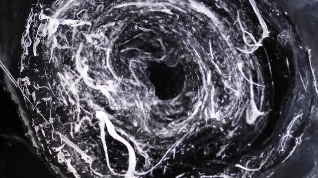 From deep in a dark tunnel white wisps drift up and up and up  -  an all natural AbstractVideoClip