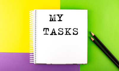 Minimal work space : sketchbook on the colorful background with MY TASKS text