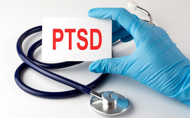 Card with text PTSD , pills and stethoscope. Medical concept.