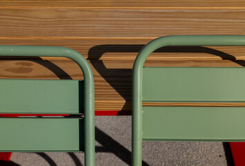 Green outdoor chairs and wood table