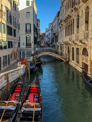Fototapeta na wymiar venetian canal and old brick houses in Venice, Italy