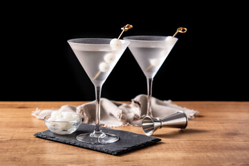 Gibson martini cocktail with onions on wooden table