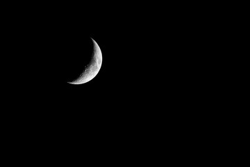 Obraz na płótnie Canvas Half moon crsecent closeup sharp details moon black background