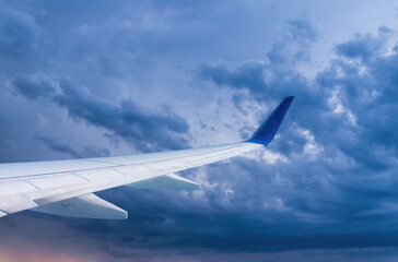 Wing of a passenger plane and the sky overboard	