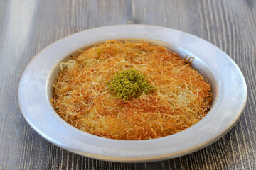 Delicious traditional Turkish kunefe with pistachio on it. Served hot and with syrup
