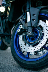 View of a sports charged motorcycle. with low profile rubber and chrome brakes. Vertical concept.