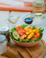 fresh vegetable salad with tomatoes and cucumber on wooden background