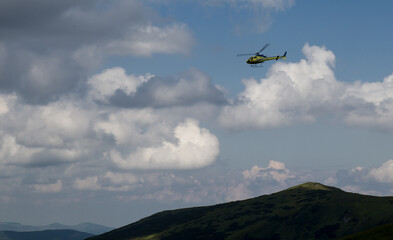 helicopter in the mountains among the clouds