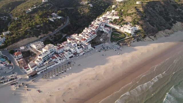 Aerial perspective of idyllic Praia da Salema beach in Algarve Portugal.