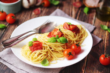 Italian pasta spaghetti with basil and cherry tomatoes	
