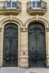 Old French house with traditional balconies and windows. Paris, France.