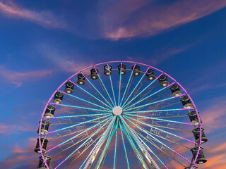 Fototapeta premium High Ferris Wheel on a sunset backdrop in our summer vacation. Amusement park ride. Adriatic coast in Slovenia. 