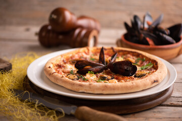 Seafood Pizza on Rustic Wood Table close up