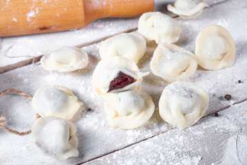 Chocolate dumplings on a white wooden background. Sweet dumplings.Top view. Dumplings with chocolate and cherries in the section.