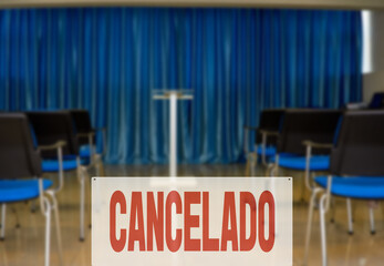 Spanish inscription CANCELED. Hall for business meeting without people due to event cancellation