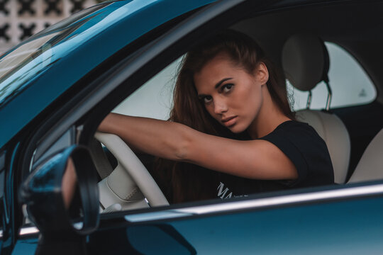 Sexy girl posing inside the car.