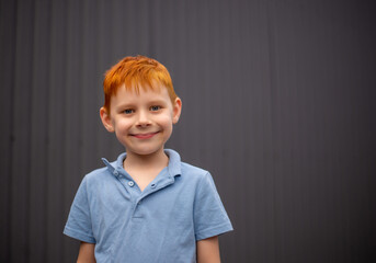 portrait of a seven-year-old boy with red hair