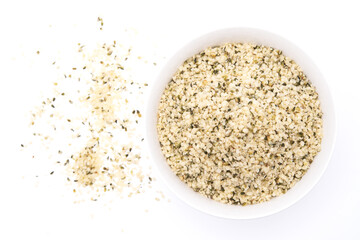 Shelled hemp seeds in wooden bowl on white background. top view with copy space