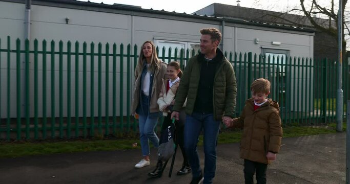 Family Safely Walking Home From School