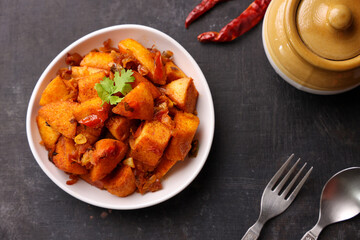 Masala Idli or Masala idly coconut chutney green chutney popular breakfast of Kerala Tamil Nadu South India and Sri Lanka. Healthy steamed rice cakes steaming fermented batter of black lentils , rice.