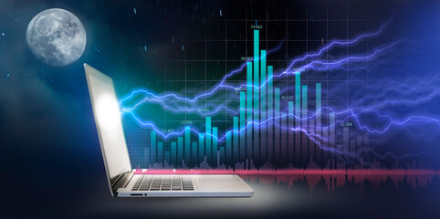 Laptop with thunderbolt-like growth graph chart and the moon night background.Financial Graph.Stock...