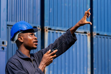 black african amarican man worker working control loading freight containers at commercial shipping...