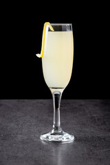 French 75 cocktail in glass on black background