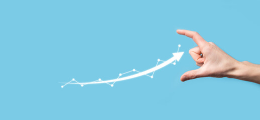 Businessman hold drawing on screen growing graph, arrow of positive growth icon.pointing at creative business chart with upward arrows.Financial, business growth concept.